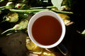 Dried Lapsang Souchong tea leaves in a wooden cup, showcasing the traditional smoked tea from Lake Missoula Tea Company.