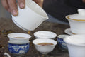 Dripping cup of Panda Gold tea by Lake Missoula Tea Company, showcasing the rich golden brew in a ceramic tea cup.