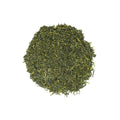 Freshly brewed The Emperor Gyokuro green tea from Lake Missoula Tea Company, featuring vibrant green tea leaves in a clear cup.