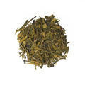Fresh Dragonwell tea leaves from Lake Missoula Tea Company, showcasing vibrant green, hand-picked tea leaves in a close-up shot.