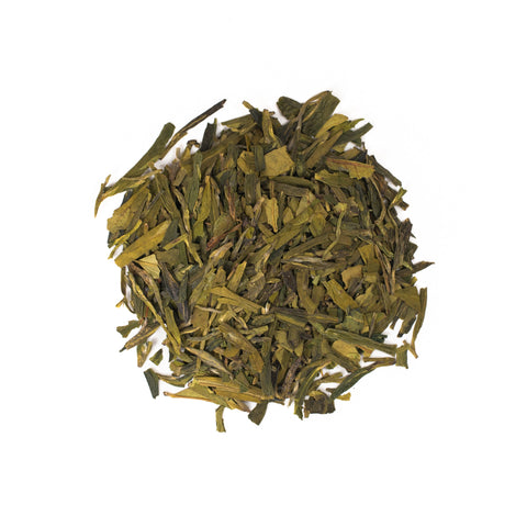 Fresh Dragonwell tea leaves from Lake Missoula Tea Company, showcasing vibrant green, hand-picked tea leaves in a close-up shot.