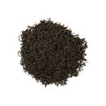 Darjeeling Shanti Hathi tea from Lake Missoula Tea Company in a teapot with tea leaves and a cup on a wooden table.