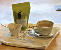 Cup of No Thyme for Cold & Flu herbal tea by Lake Missoula Tea Company in a glass mug with fresh thyme sprigs.