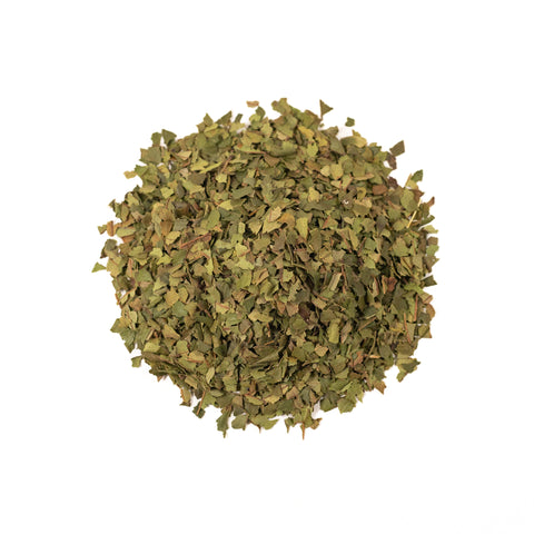 Lemon Myrtle tea by Lake Missoula Tea Company showing dried lemon myrtle leaves in a clear glass jar.