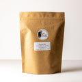 Loose dry Genmai Cha tea leaves from Lake Missoula Tea Company in a 500g package, showing toasted rice and green tea leaves.
