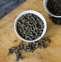 Cup of Ginseng Oolong tea from Lake Missoula Tea Company, showing a steaming brewed tea in a white ceramic cup.