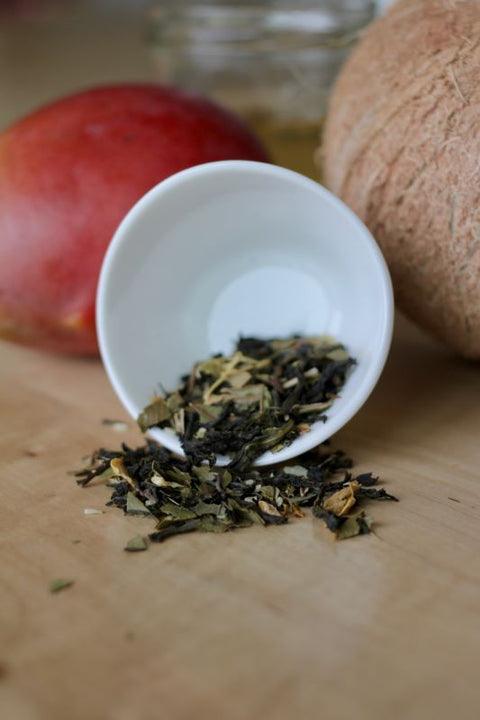 Green tea in a white cup with mango flavor from Lake Missoula Tea Company, showcasing the Glacial Mango Tango tea blend.