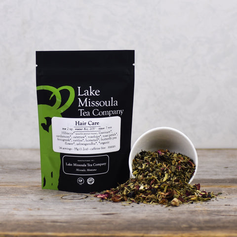 2oz bottle of Lake Missoula Tea Company hair care tea for scalp and hair health, with a natural herbal infusion in a clear bottle.