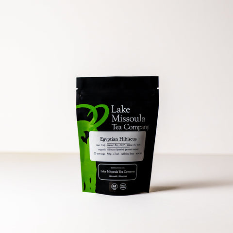 Dried hibiscus tea leaves in a clear jar from Lake Missoula Tea Company, vibrant red and deep in color.
