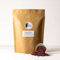 Dried hibiscus tea leaves in a 500g package from Lake Missoula Tea Company, showcasing vibrant red hibiscus petals.