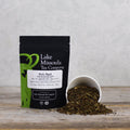 Fresh holy basil tea leaves from Lake Missoula Tea Company in a 2oz package, showcasing vibrant green herbs for brewing.
