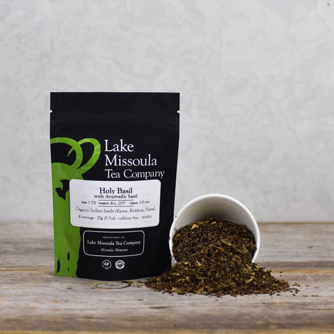 Fresh holy basil tea leaves from Lake Missoula Tea Company in a 2oz package, showcasing vibrant green herbs for brewing.