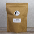 Fresh dried holy basil tea leaves from Lake Missoula Tea Company in a 500g package, showing vibrant green herbs.