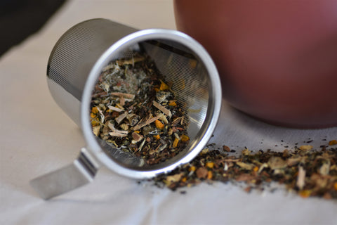 Loose leaf Joint Peace Arthritis Blend tea by Lake Missoula Tea Company in a clear glass jar with tea leaves visible inside.