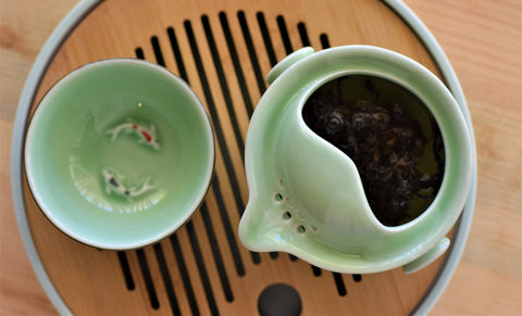 Koi fish and Gaiwan tea brewing set with Emperor Gyokuro tea from Lake Missoula Tea Company, featuring a traditional ceramic gaiwan.