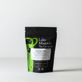 Two-ounce package of Lake Missoula Tea Company Licorice Mint herbal tea with fresh mint leaves and licorice root in clear packaging.