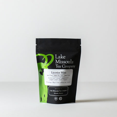 Two-ounce package of Lake Missoula Tea Company Licorice Mint herbal tea with fresh mint leaves and licorice root in clear packaging.