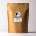 Loose Moroccan Mint tea leaves from Lake Missoula Tea Company in a clear glass jar showing fresh green leaves.