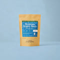 Mountain Winter Berry tea in a kraft pouch with a blue label on a light blue background