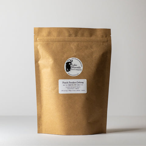 Dry Peach Peridot Oolong tea leaves from Lake Missoula Tea Company in a 500g package, showcasing fresh, colorful tea leaves.