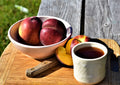 Pleistocene Peach tea by Lake Missoula Tea Company, featuring fresh peaches on a cutting board with a tea cup.