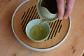 Pouring gyokuro green tea from a gaiwan, showcasing The Emperor Gyokuro by Lake Missoula Tea Company.