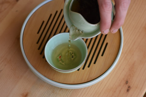 Pouring gyokuro green tea from a gaiwan, showcasing The Emperor Gyokuro by Lake Missoula Tea Company.