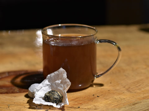 Assorted Puerh tea sampler from Lake Missoula Tea Company, featuring tea buttons and compact packaging.