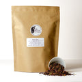 A 500g package of Lake Missoula Tea Company's Rose Chai with aromatic rose and chai spices in a colorful, inviting tea blend.