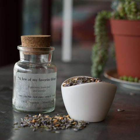 Jar of Lake Missoula Tea Company's "A Few of My Favorite Things" dark tea blend, with tea leaves and aroma visible in the image.