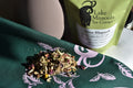 Loose leaf Sweet Rhapsody tea from Lake Missoula Tea Company displayed on a bandana. Bright, aromatic tea leaves in natural setting.