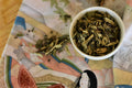 Loose leaf Who Chic tea by Lake Missoula Tea Company in a clear glass jar with a label and tea leaves visible inside.