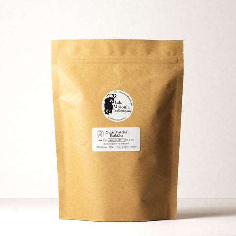 A 500g package of Lake Missoula Tea Company's Yuzu Matcha Kuki Cha tea with green tea leaves and yuzu citrus flavor.