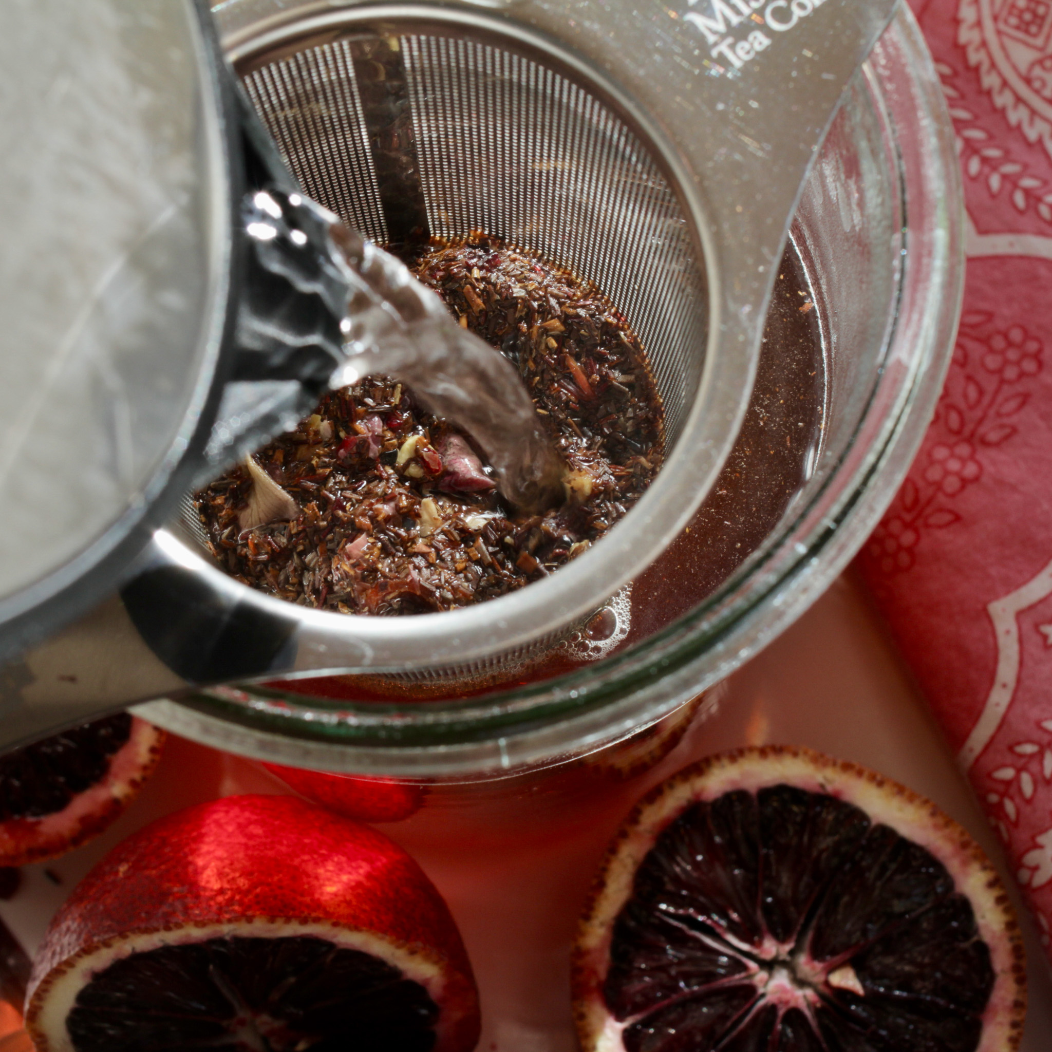 Steeping Blood Orange Rooibos with stainless steel strainer